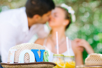 Wedding couple having picnic outside in park in summer - 90832429