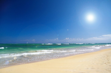 Sea waves with foam on white tropical sandy beach