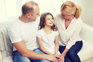 happy parents with little daughter at home