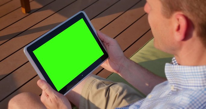 Man Uses Blank Green Screen Tablet PC Outside