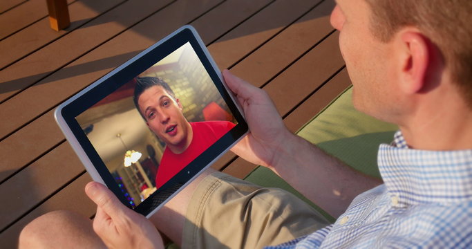 Man Videochats Outside with Tablet PC