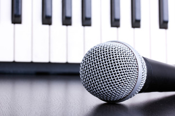 Microphone on piano keyboard background