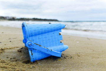 Fototapeta na wymiar abandoned toy bucket on the beach