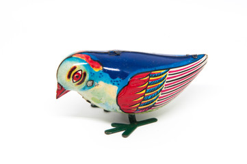 Antique tin toy blue bird isolated on white background