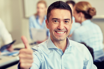 group of smiling businesspeople meeting in office