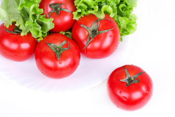 Tomatoes and salad leaf on plate