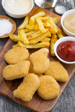 chicken nuggets with french fries and tomato sauce, top view
