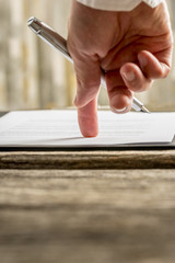 Low angle view of  businessman hand pointing with his finger whe