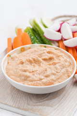 tomato sauce with tofu and fresh vegetables on wooden board