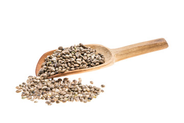 Hemp seeds on a wooden spoon with handle to the right isolated on white