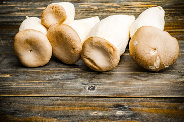 Fresh King Oyster mushroom (Eringi) on wooden background,food ingredient