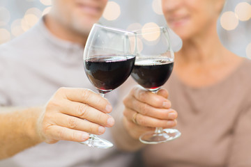 close up of happy senior couple with red wine