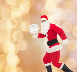 man in costume of santa claus with clock