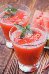 Watermelon smoothie on a wooden table.