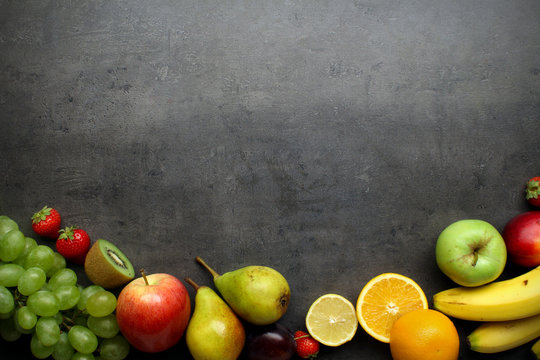 Fresh fruits on grey kitchen table