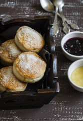 English scones for Breakfast in a vintage tray on brown wooden background
