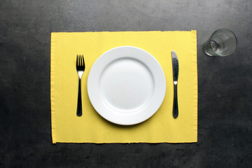 Table setting for one person on dinning table, top view
