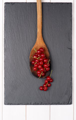 Currants in a wooden spoon