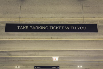 Parking garage ticket and exit sign