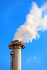Dense smoke from a chimney, blue sky