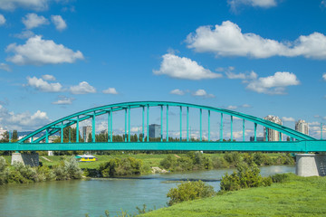 Green Railway bridge over Sava river in Zagreb and modern skyline