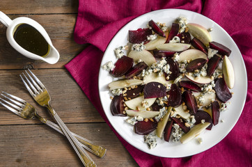 Apple salad with beetroot and walnuts blue cheese dressed with balsamic vinegar   