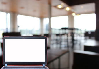 Blurred background : laptop in restaurant blur background with b