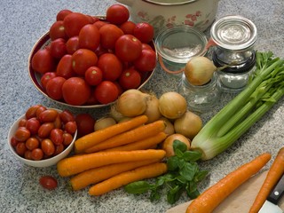 sauce contain tomato, onion, carrot, petiolate celery and basil leaves. Seasonly riped vegetables with old fashion preserving jars, cooking pot. 
