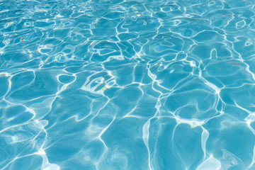 Pool water background with sun reflections
