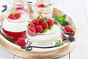Panna cotta with fresh raspberries. Selective focus.