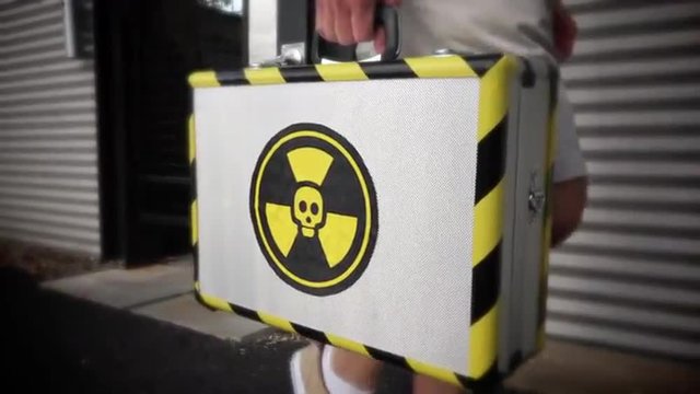 An anonymous man walks outside with a mysterious and dangerous looking metal briefcase. Shot at 60fps for optional slow motion use.