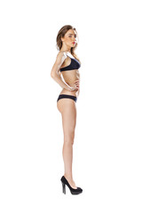 Fototapeta na wymiar Full length portrait of a beautiful young model in black bikini