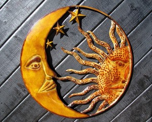 Sun and moon profiles on a wooden panel background