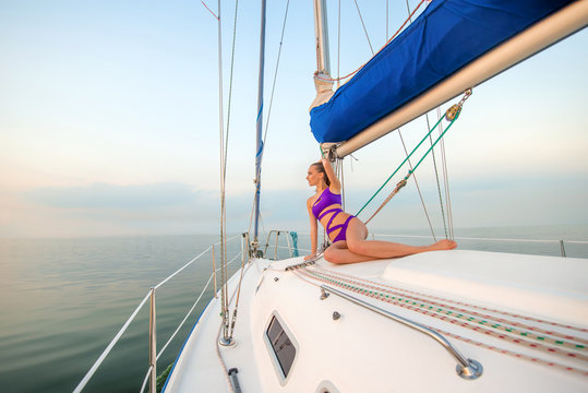 Beautiful girl sunbathing on the yacht. 