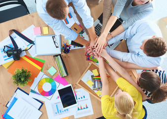 Business team with hands together - teamwork concepts