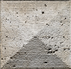 Old ashlar wall made of dolomite rock carved in geometrical pattern