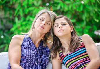 Mother Relaxing At Home With Daughter