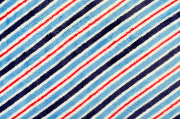 Blue and orange with white striped background. Diagonal stripes pattern on fabric.