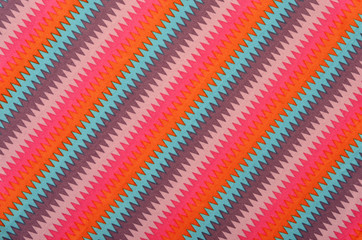 Colorful zig zag striped background. Diagonal stripes pattern on fabric.