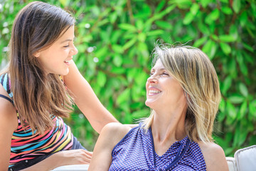 Fototapeta premium Mother and daughter hugging, smiling and sharing. Mothers day co