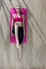 Top view, young woman doing stretching exercises