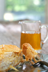 Baklava, delicious pastry dessert made with phyllo dough, nuts, butter and sugar served on a plate with a jar of honey