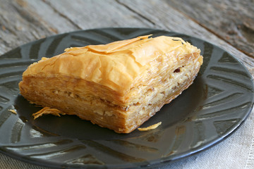 Baklava, delicious pastry dessert made with phyllo dough, nuts, butter and sugar served on a plate
