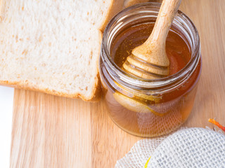 Golden honey with honeystick and bread