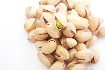 Heap of pistachios nuts isolated on the white