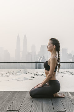 Woman Doing Yoga in a Big City