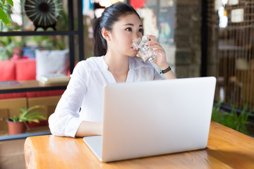beautiful hipster woman using laptop at cafe