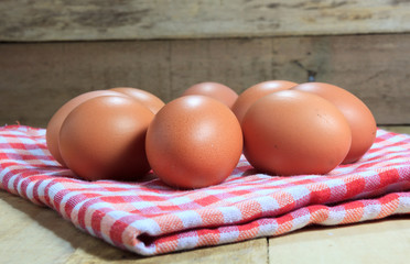 The eggs and cloth on the blur wood background.