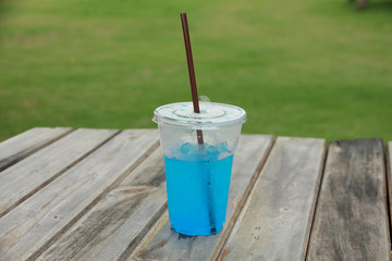 Stock Photo:.Blue cocktail in a glass on old wooden background
