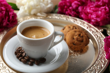 Composition with cup of coffee, muffins and peony flowers on tray, on wooden background